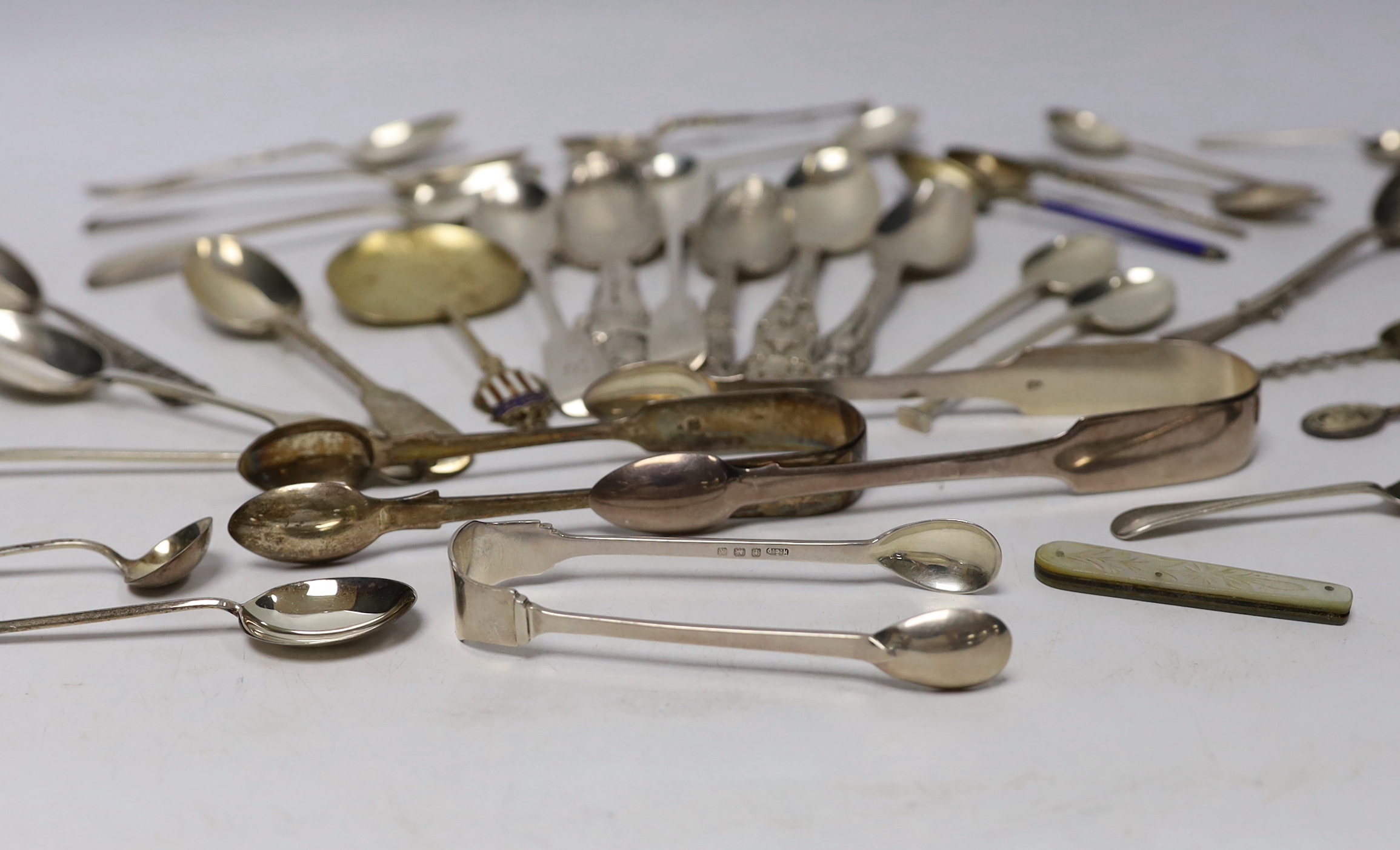 A small group of assorted silver and sterling small spoons, including commemorative etc. and some continental white metal spoons.
